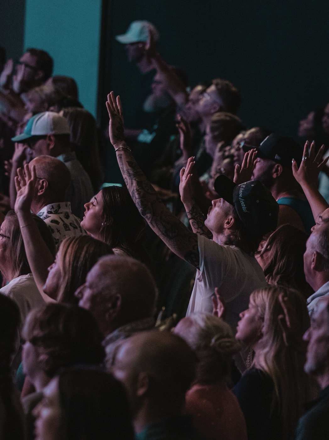 People worshiping with hands raised at Lakeside